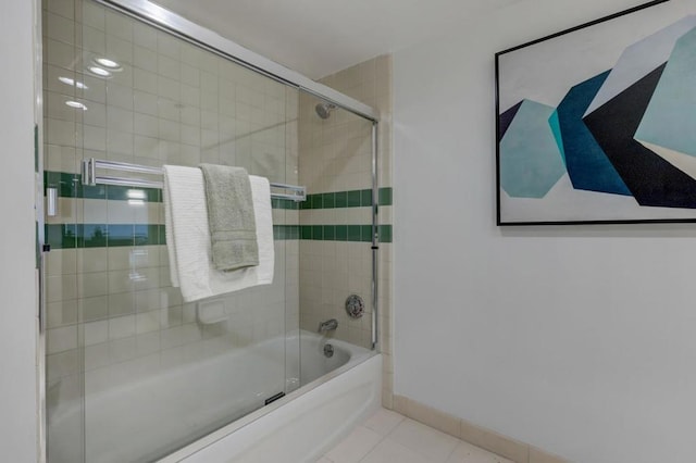 bathroom with tile patterned floors and shower / bath combination with glass door