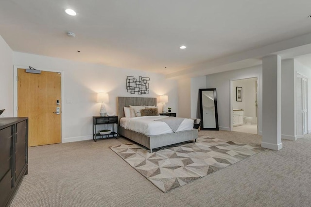 bedroom featuring light colored carpet and connected bathroom