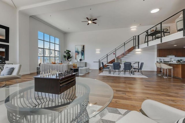 living room with ceiling fan and wood-type flooring