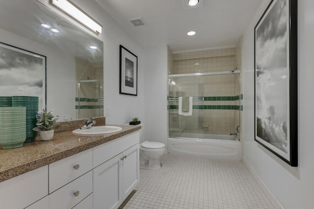 full bathroom featuring tile patterned floors, bath / shower combo with glass door, toilet, and vanity