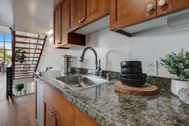 kitchen with sink, wood-type flooring, and dishwasher