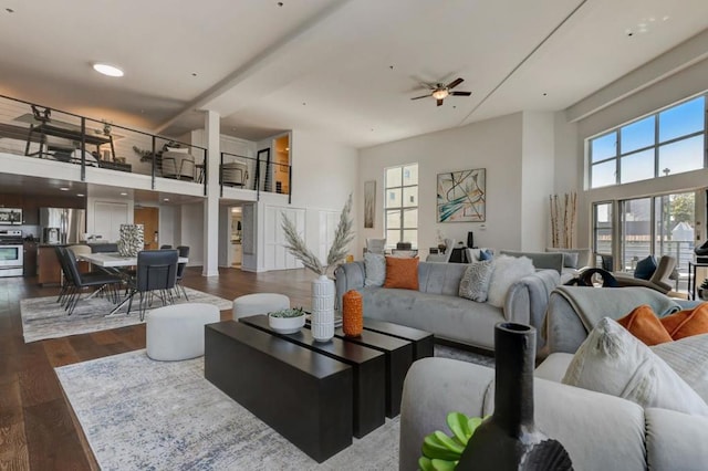 living room with dark hardwood / wood-style floors and ceiling fan