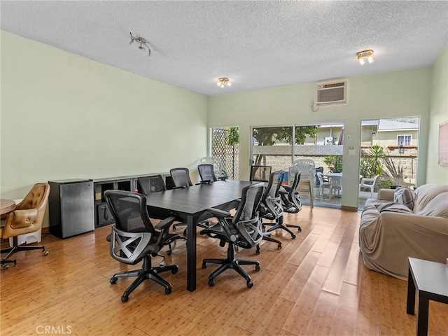 1901 Peyton Ave Unit T, Burbank, CA 91504 - dining space featuring light hardwood / wood-style floors, an AC wall unit, and a textured ceiling