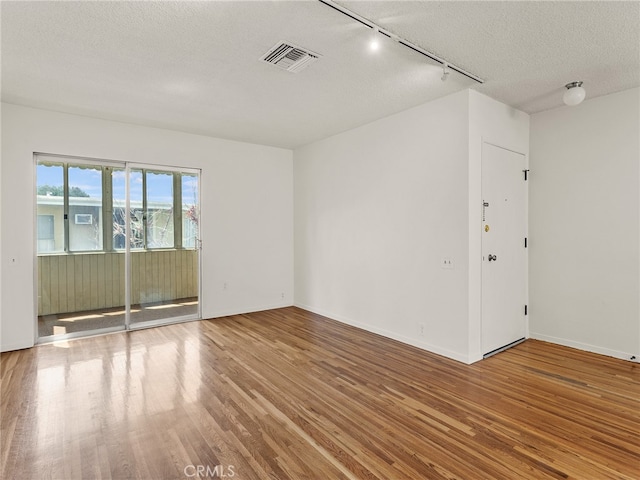 1901 Peyton Ave Unit T, Burbank, CA 91504 - spare room with hardwood / wood-style flooring, track lighting, and a textured ceiling