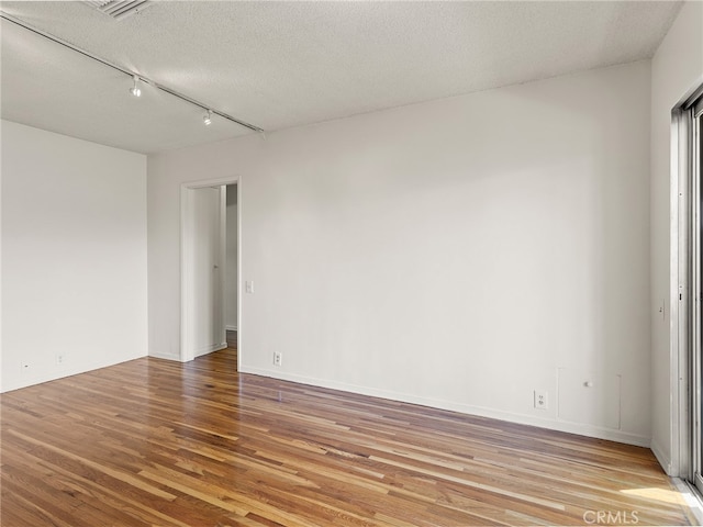 1901 Peyton Ave Unit T, Burbank, CA 91504 - empty room with a textured ceiling, hardwood / wood-style flooring, and track lighting