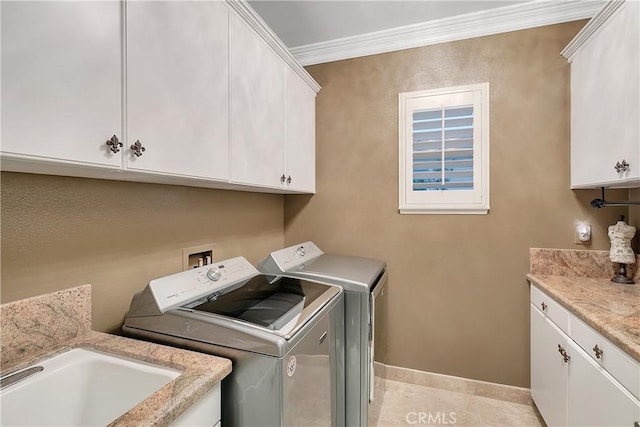 clothes washing area featuring light tile patterned flooring, cabinets, ornamental molding, and independent washer and dryer