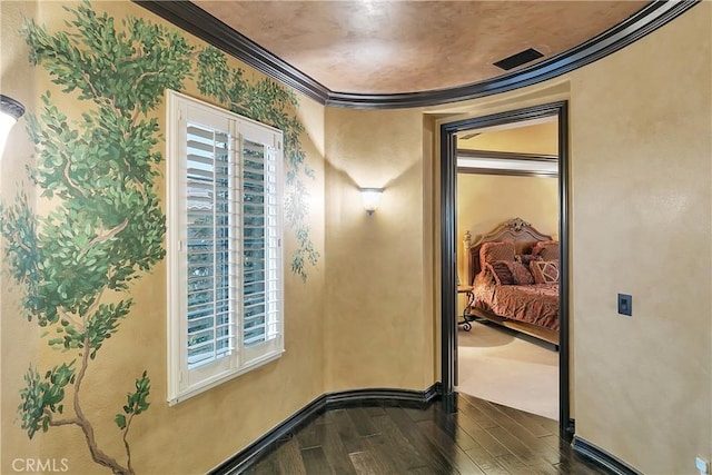 interior space featuring a healthy amount of sunlight, dark wood-type flooring, and crown molding