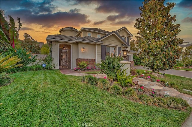 view of front of property with a lawn