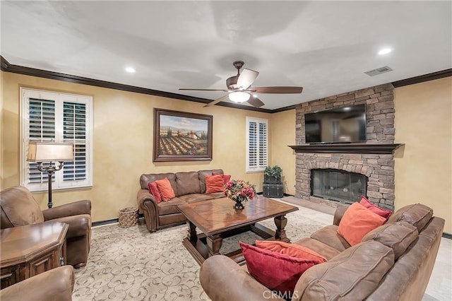 living room featuring ceiling fan, a fireplace, and ornamental molding