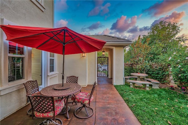 patio terrace at dusk with a yard