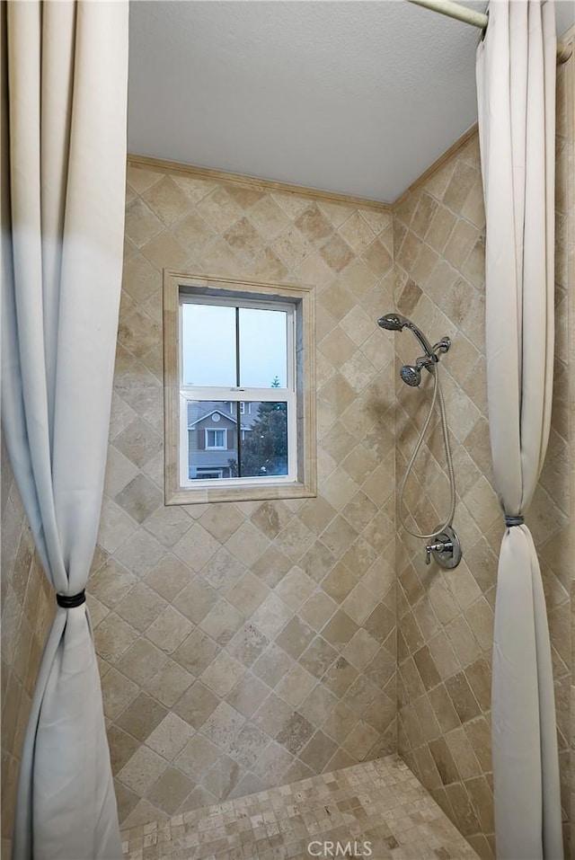 bathroom featuring crown molding and curtained shower