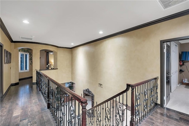 hallway with dark wood-type flooring and ornamental molding