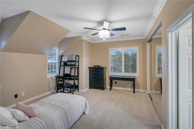 carpeted bedroom with ceiling fan and ornamental molding