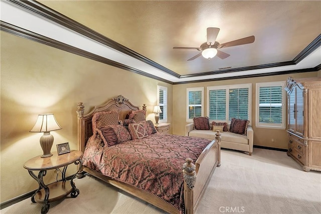 bedroom featuring ceiling fan, crown molding, light colored carpet, and a raised ceiling