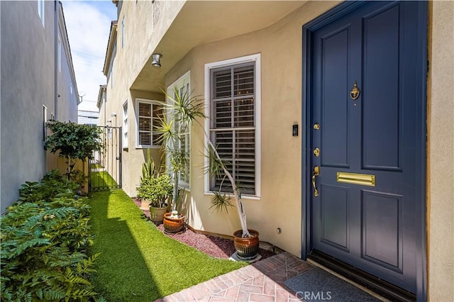 entrance to property with a lawn