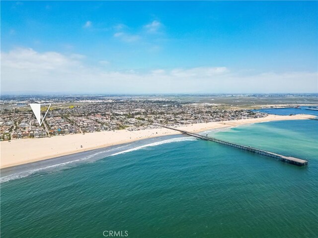 bird's eye view with a water view and a beach view