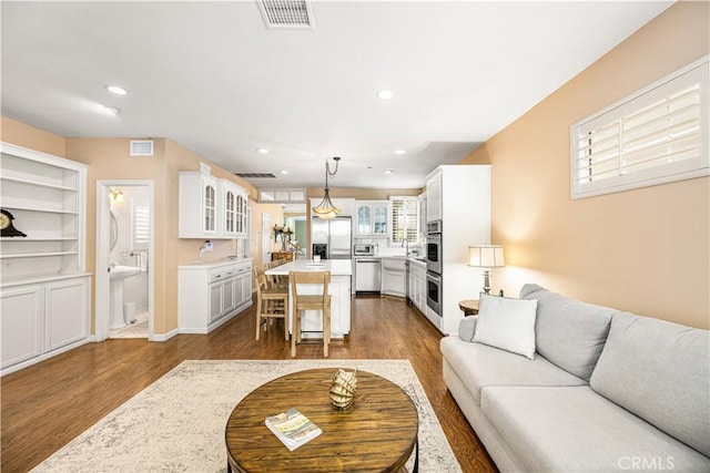 living room featuring hardwood / wood-style flooring and sink