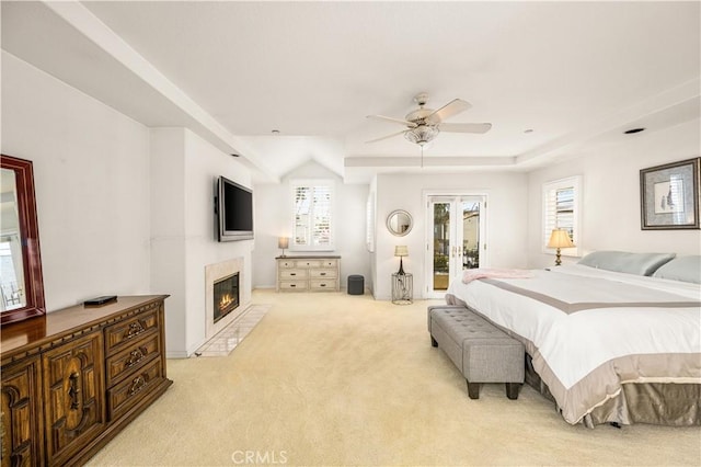 carpeted bedroom featuring multiple windows, access to outside, french doors, and ceiling fan