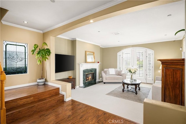 living room with ornamental molding, dark hardwood / wood-style floors, and a high end fireplace