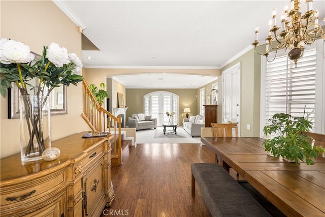 dining room featuring a notable chandelier, ornamental molding, and dark hardwood / wood-style floors