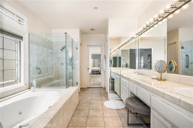 bathroom featuring vanity, independent shower and bath, and tile patterned flooring