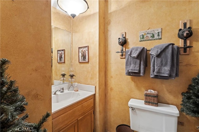 bathroom with toilet and vanity