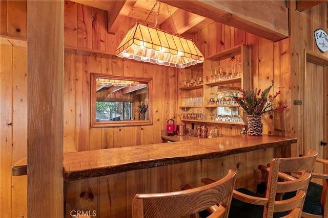 bar featuring wooden ceiling, wooden walls, and beamed ceiling