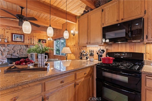 kitchen with a fireplace, pendant lighting, black appliances, beam ceiling, and light stone counters