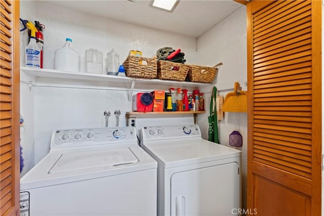 clothes washing area featuring independent washer and dryer