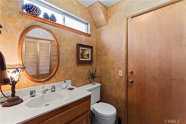 bathroom with toilet and vanity