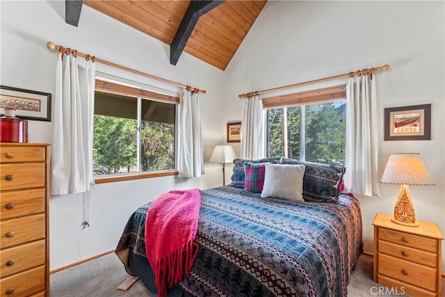 carpeted bedroom with wooden ceiling and vaulted ceiling with beams