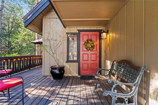 view of exterior entry with a deck