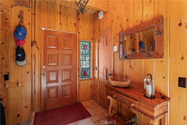 entryway with wood walls