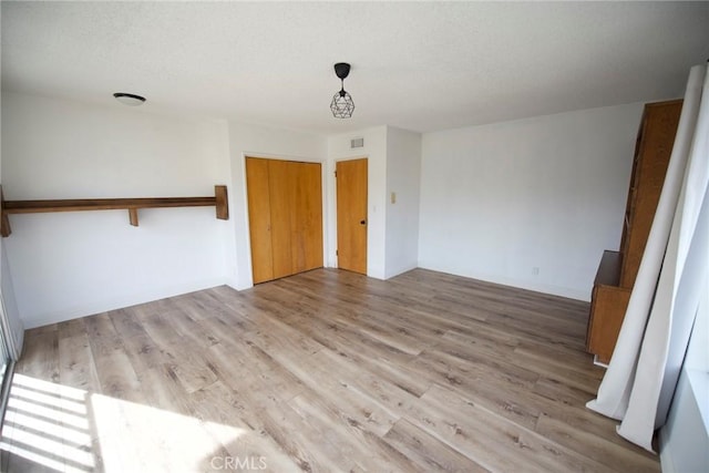 spare room with light hardwood / wood-style flooring