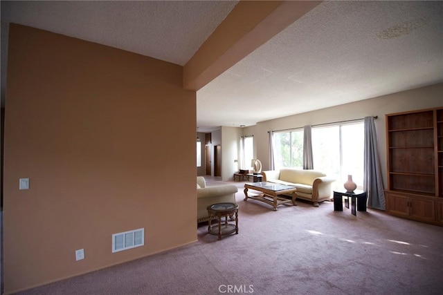 carpeted living room featuring a textured ceiling