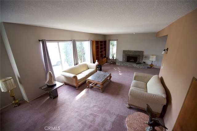 living room featuring a stone fireplace, carpet floors, and a textured ceiling