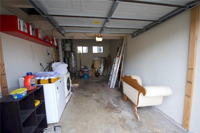 garage featuring separate washer and dryer, secured water heater, and a garage door opener