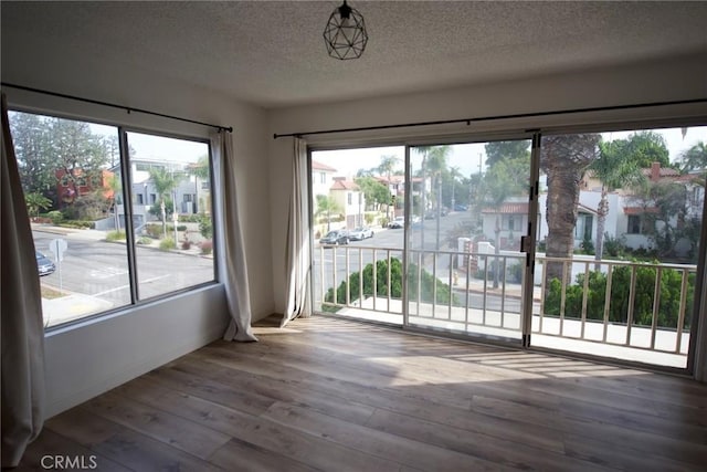 interior space featuring hardwood / wood-style floors and a textured ceiling