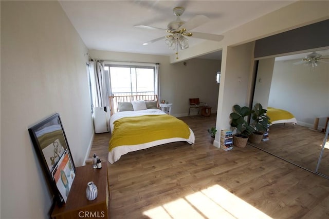 bedroom with hardwood / wood-style flooring, ceiling fan, and a closet