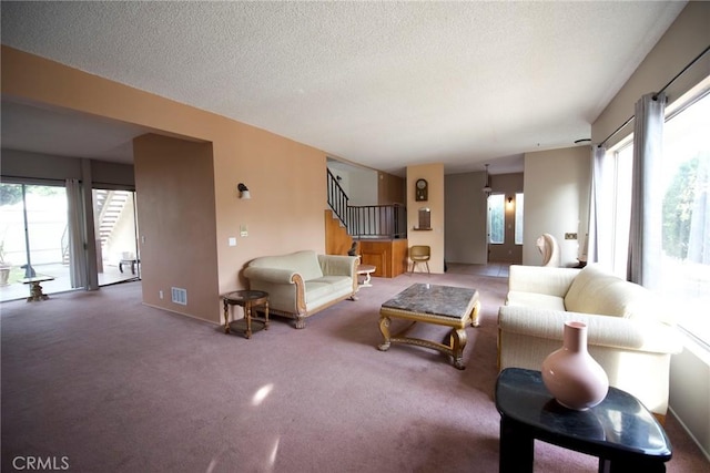 living room with carpet and a textured ceiling