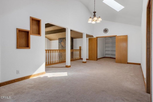 bonus room with a skylight, beam ceiling, carpet, and an inviting chandelier