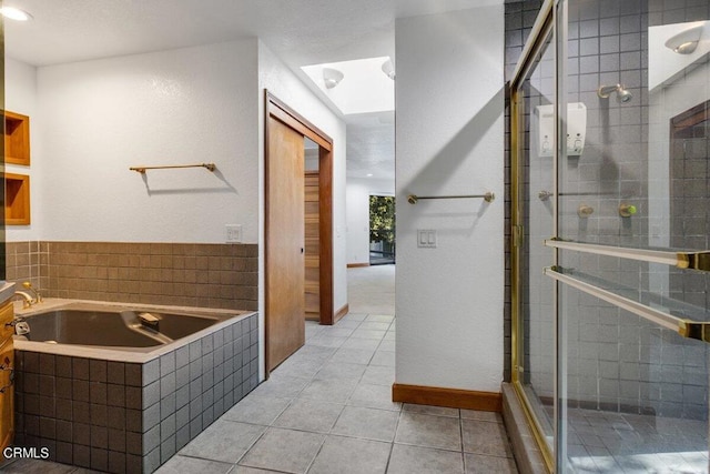 bathroom with tile flooring and independent shower and bath