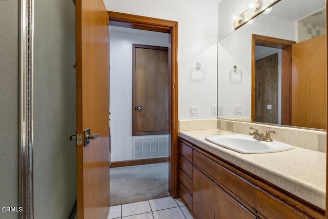 bathroom with vanity and tile flooring