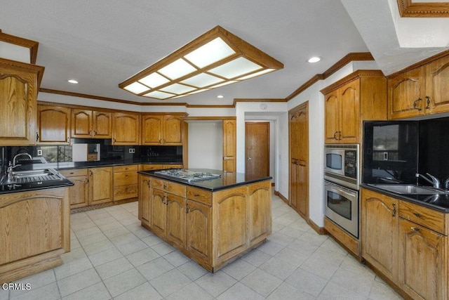 kitchen with appliances with stainless steel finishes, a center island, light tile floors, sink, and backsplash