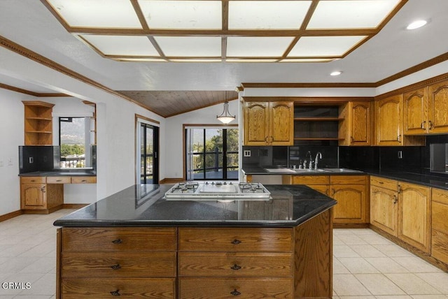 kitchen featuring a center island, light tile floors, sink, backsplash, and lofted ceiling