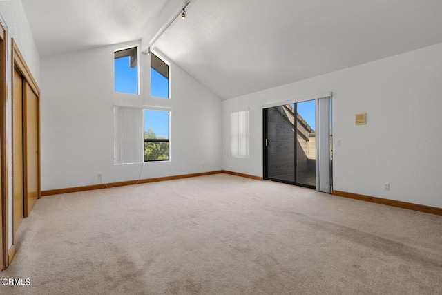 interior space with beam ceiling, high vaulted ceiling, and carpet floors