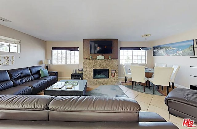 living room with a wealth of natural light and light tile patterned floors