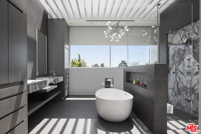 bathroom featuring vanity, independent shower and bath, and a chandelier