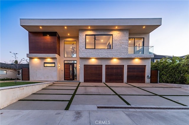 modern home with a garage and a balcony