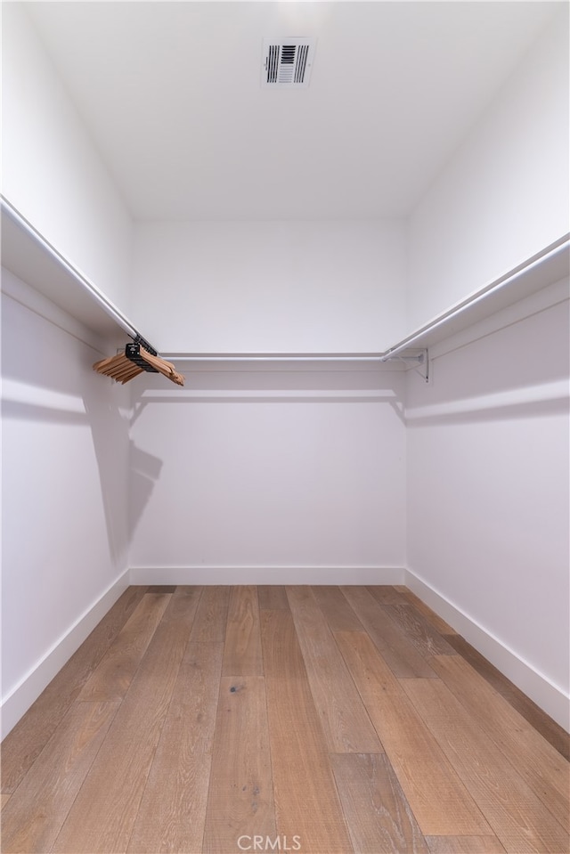 spacious closet featuring hardwood / wood-style flooring